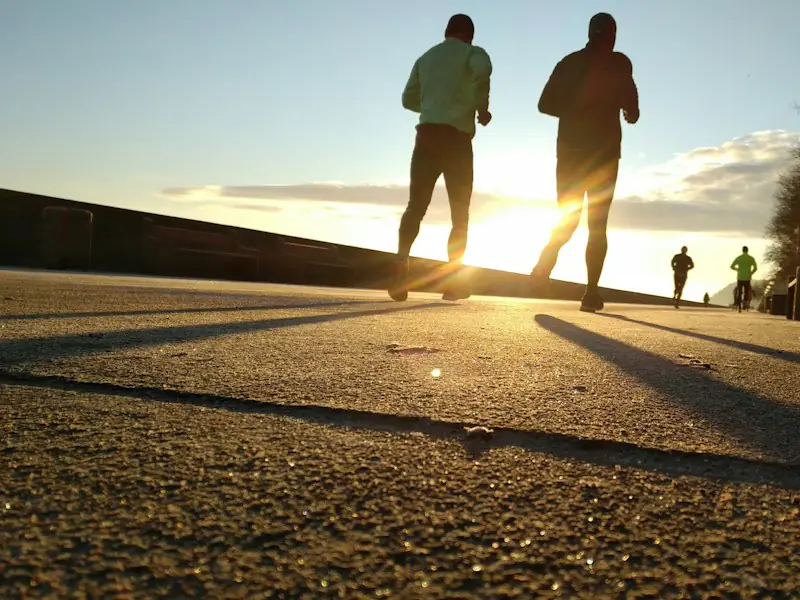 Deux coureurs de dos face au soleil